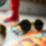 A close-up of stylish circle sunglasses resting on a skateboard deck