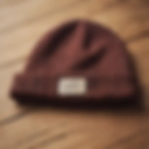 A stylish beanie displayed on a wooden surface, showcasing its texture and color.