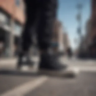 A pair of all black Converse high tops on a city street