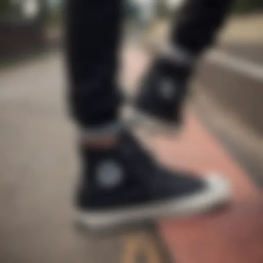 Stylish all black Converse high tops on a skateboarding ramp