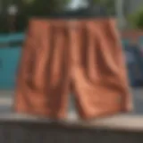 A stylish pair of baggy corduroy shorts displayed on a vibrant skate park backdrop