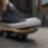 Close-up view of black on black Converse low tops on a skateboard