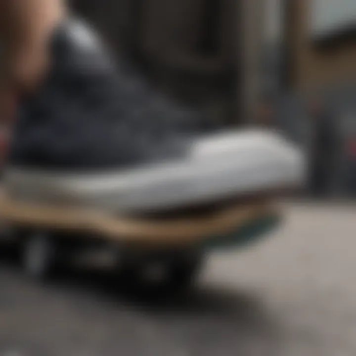 Close-up view of black on black Converse low tops on a skateboard