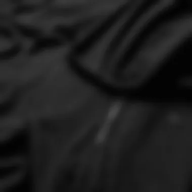 Texture Detail of Black Oversized Hoodie Close-up of fabric showcasing the texture of a black oversized hoodie
