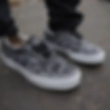 Close-up of black tie dye Vans with intricate patterns