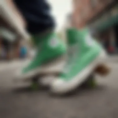 A close-up of green high tops Converse on a skateboard