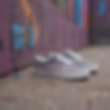 Grey Vans sneakers placed on a graffiti-covered surface