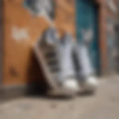 Artistic perspective of Adidas Superstar camouflage shoes against urban graffiti