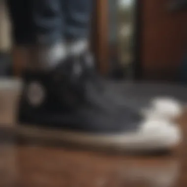 Chuck Taylors: A Staple in Skateboarding Black on black Chuck Taylors on a skateboard deck