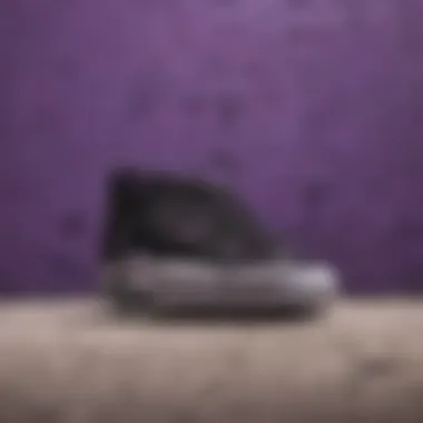 Black and Purple Vans Against Graffiti Art An array of black and purple Vans displayed against a colorful graffiti backdrop