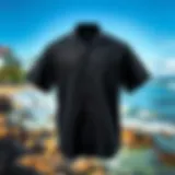Stylish black beach shirt displayed against a vibrant coastal background