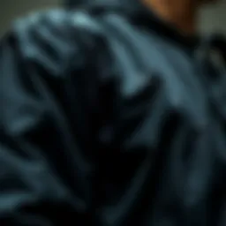 A close-up view of the black coach jacket showcasing its fabric texture and design details