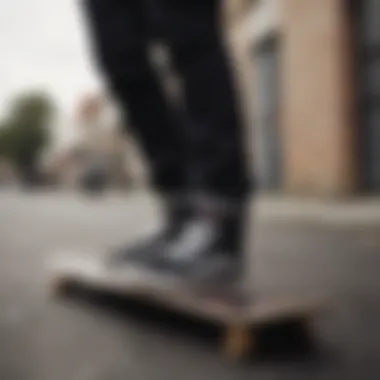 A close-up of black jeans worn by a skater