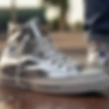 Close-up of silver high top Converse with skate gear