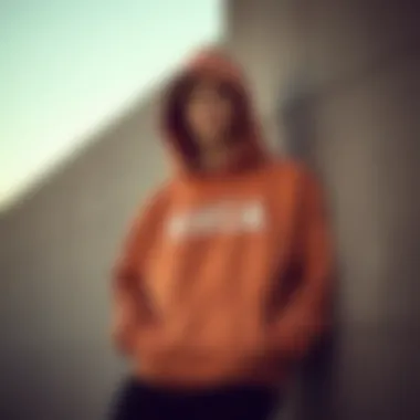 Street Style: Comfort and Identity in Big RVCA Hoodie A street-style shot of a skater leaning against a wall, showcasing personal style and comfort in a big RVCA hoodie.