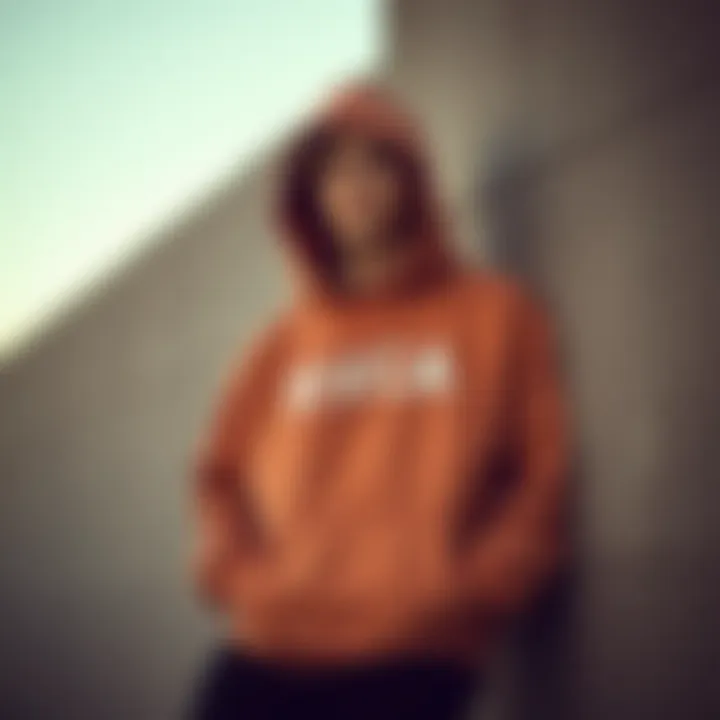 Street Style: Comfort and Identity in Big RVCA Hoodie A street-style shot of a skater leaning against a wall, showcasing personal style and comfort in a big RVCA hoodie.