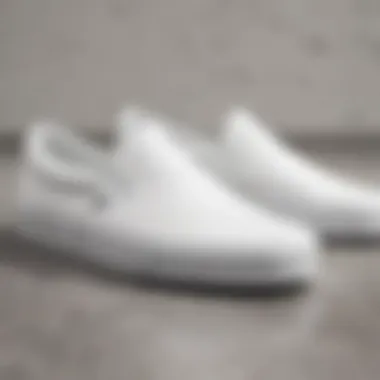 Close-up of the design features of white Vans slip-ons