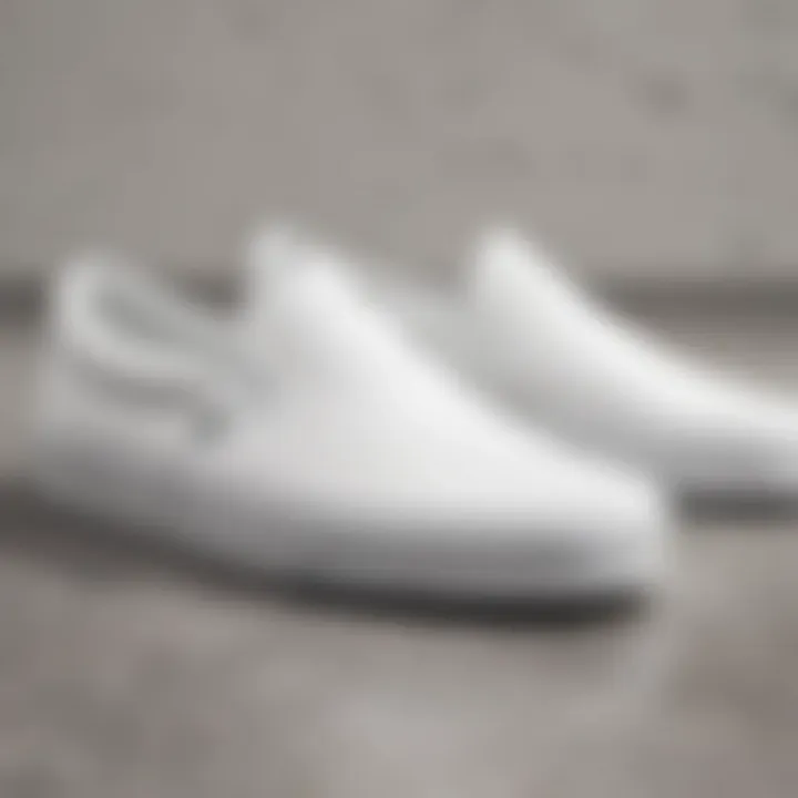 Close-up of the design features of white Vans slip-ons