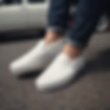 A pristine pair of white Vans slip-ons