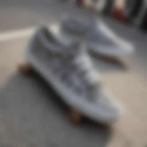 A pair of grey checkered Vans on a skateboard