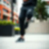 Black Nike track pants showcased in an urban skate park setting