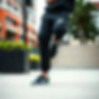 Black Nike track pants showcased in an urban skate park setting