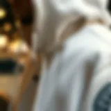 A close-up of a white designer hoodie showcasing intricate stitching and branding details