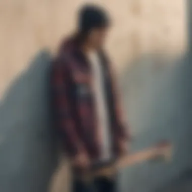 A skateboard leaning against a wall next to a stylish flannel jacket.