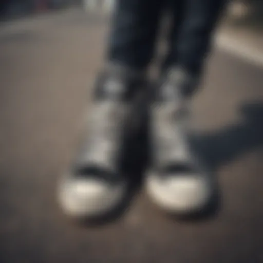 A pair of stylish Converse black sneakers on a skateboard.