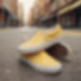 Light yellow slip-on Vans against a vibrant urban backdrop